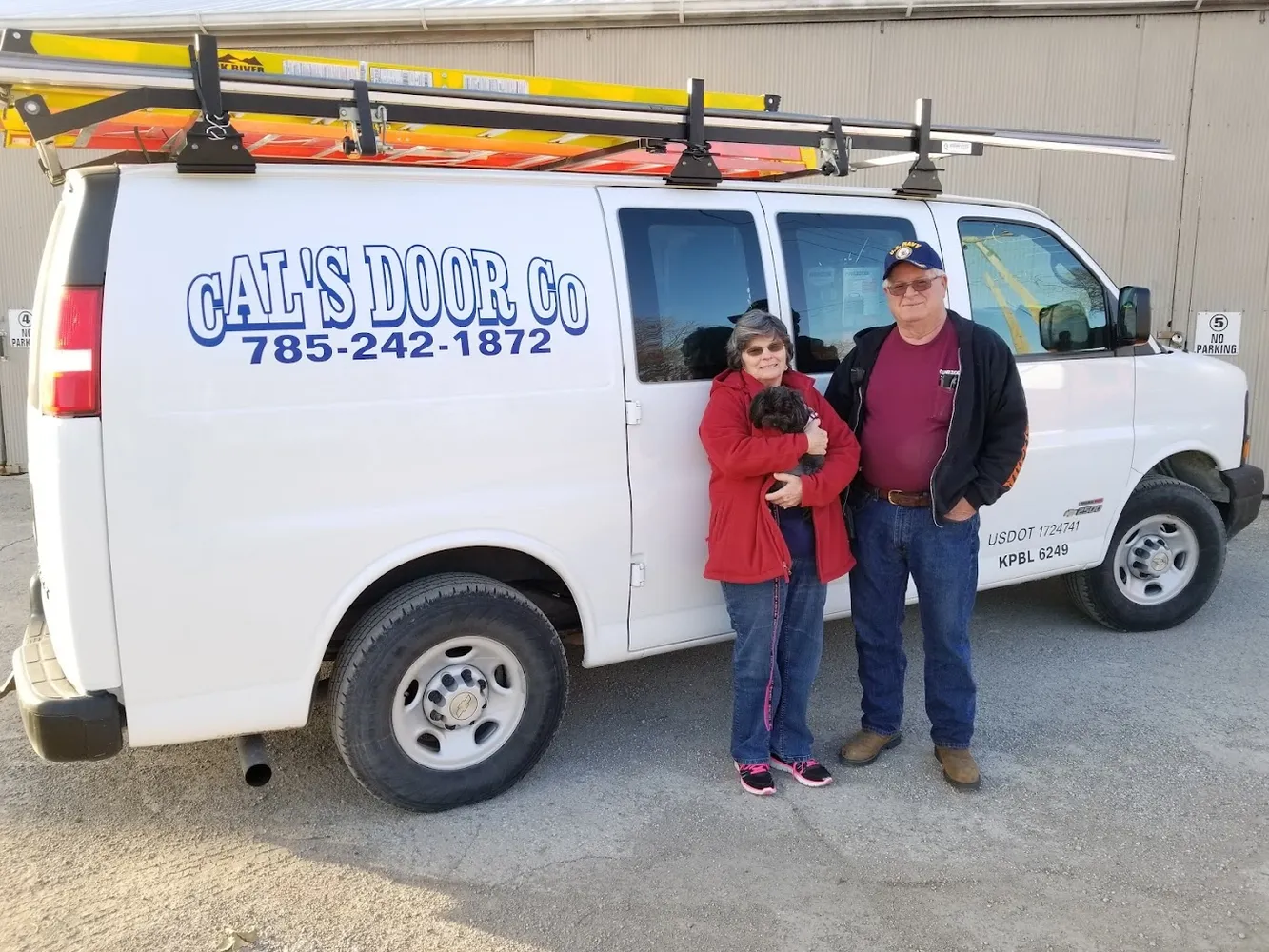 Dave and Charlene Gibbs standing beside their van